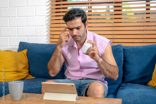 A man videocall conference by tablet, consulting his physician by online telemedicine service center describe his illness and asking about the medicine he take at home.