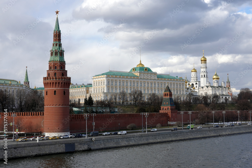 Vodovzvodnaya tower, Grand Kremlin Palace and Ivan the Great Bell Tower of Moscow Kremlin behind the wall on embankment ot the Moscow river on overcast day in off-season