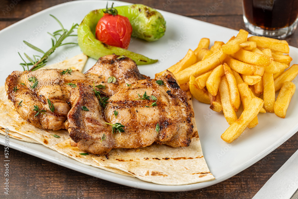 Spicy grilled chicken on a white porcelain plate Spicy grilled chicken on a white porcelain plate