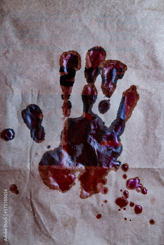 Bloody hand print on paper