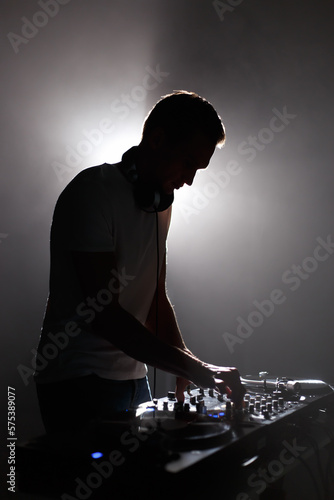 Obraz na plátně Silhouette of club dj mixing techno music