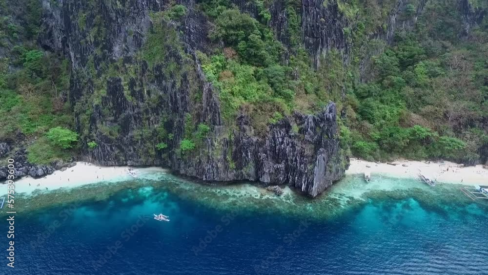 Beach in Palawan, Sightseeing Place. Tour C in El Nido, Philippines. Serene White Sand Beach With Clear Turquoise Water, Rock Formations in Background Beach in Palawan, Sightseeing Place. Tour C in El Nido, Philippines. Serene White Sand Beach With Clear Turquoise Water, Rock Formations in Background