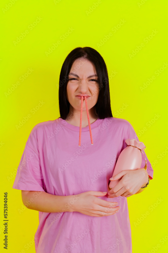 Obraz premium Charming joyful girl posing and express emotions against a bright lime green background. People emotions, Fun and carefree self-expression.
