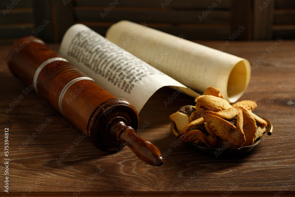 The Scroll of Esther and Purim Festival objects on a dark wooden table. Rustic.