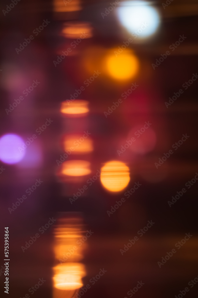 Multicolor defocused bokeh lights through a window at night, Abstract background, colorful motion blur Lights in the dark Multicolor defocused bokeh lights through a window at night, Abstract background, colorful motion blur Lights in the dark