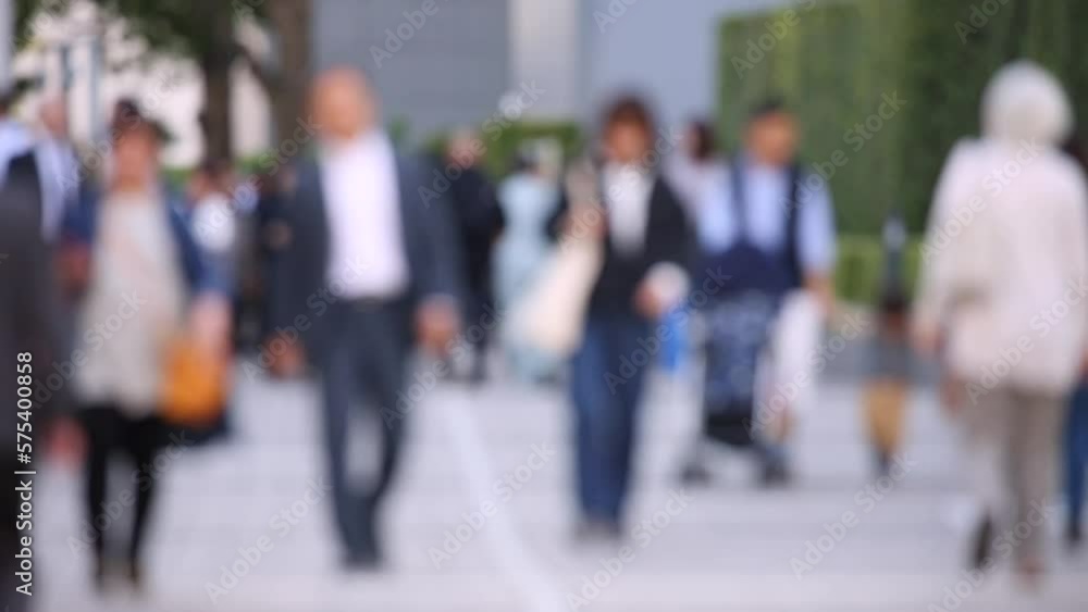 Blurry People Walking on the Sidewalk. Business District. Rush Hour Time. Asian City and Asian People. Blurry Background Blurry People Walking on the Sidewalk. Business District. Rush Hour Time. Asian City and Asian People. Blurry Background