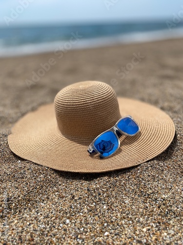 hat and sunglasses on the beach