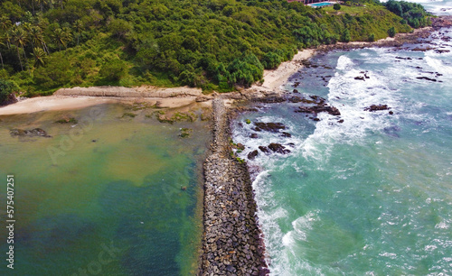 Aerial view of the sea stone breakwater. Beautiful ocean wallpaper for tourism and advertising. Asian landscape, drone photo