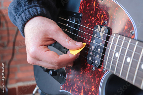 Man playing electric guitar at home