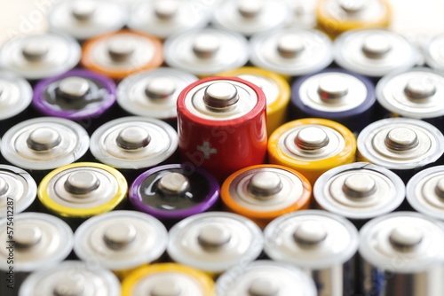 many round batteries and one red battery