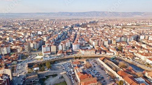 Aerial view of the city buildings, roads and traffic at sunset