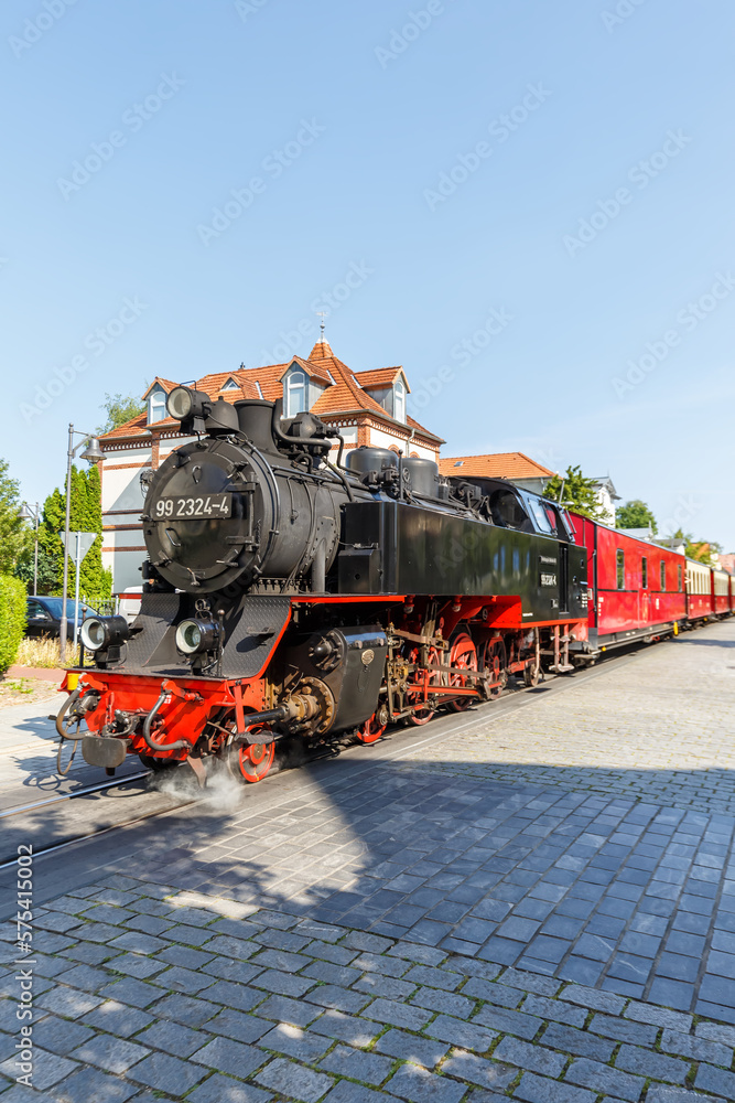 Naklejka premium Baederbahn Molli steam train locomotive railway portrait format in Bad Doberan, Germany