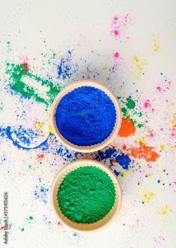 top view of colorful traditional holi powder in bowls isolated on dark background.Space for text . happy holi.Concept Indian color festival called Holi