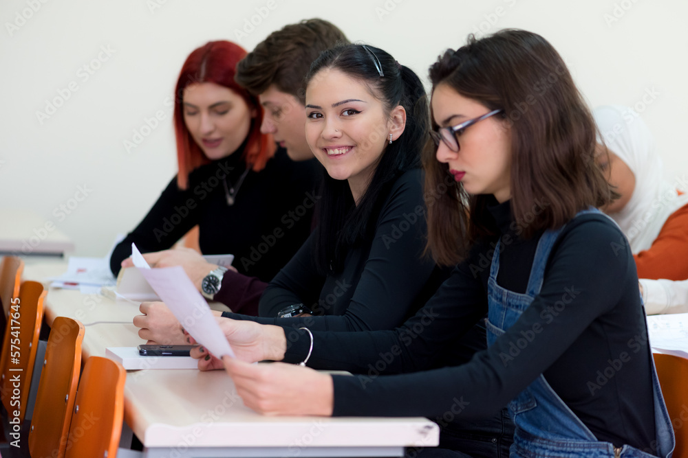 Workshop at university. View of students sitting and listening in lecture hall doing practical works Workshop at university. View of students sitting and listening in lecture hall doing practical works