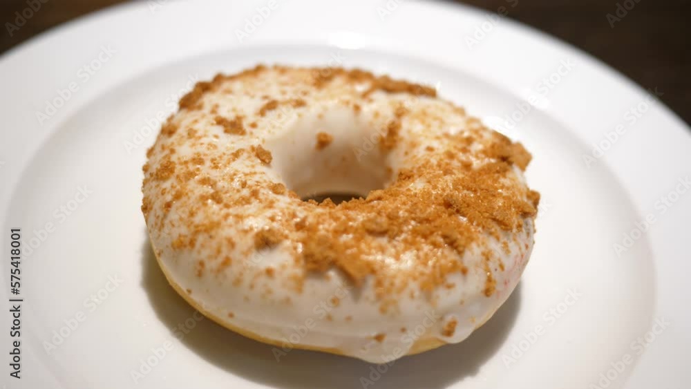 Tasty sweet donut pastry on a white plate closeup in a cafeteria Tasty sweet donut pastry on a white plate closeup in a cafeteria
