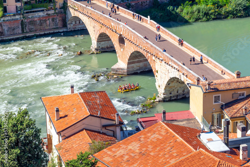 Εκτύπωση καμβά A group of rafts with rafters paddling on the Adige River under the historic Ponte Pietra bridge which leads to the historic center of Verona, Italy