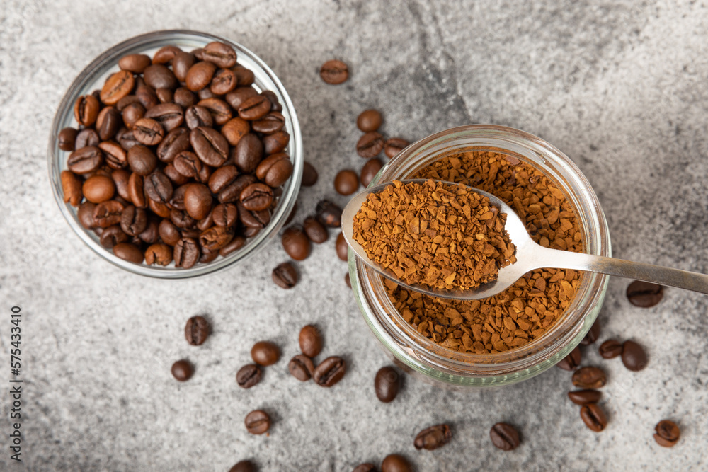 Ingredients for making coffee - coffee beans, ground and instant coffee on a black textured background. Caffeine. Decaffeinated coffee. Aroma energy hot drink. Place for text, space for copy. Ingredients for making coffee - coffee beans, ground and instant coffee on a black textured background. Caffeine. Decaffeinated coffee. Aroma energy hot drink. Place for text, space for copy.