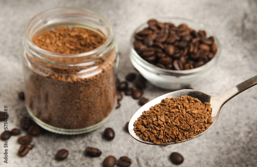 Ingredients for making coffee - coffee beans, ground and instant coffee on a black textured background. Caffeine. Decaffeinated coffee. Aroma energy hot drink. Place for text, space for copy. Ingredients for making coffee - coffee beans, ground and instant coffee on a black textured background. Caffeine. Decaffeinated coffee. Aroma energy hot drink. Place for text, space for copy.