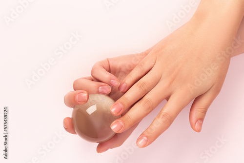 female hands with Japanese manicure on a pink background