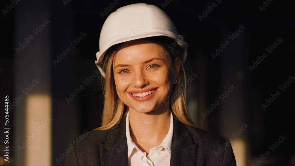 Portrait of Female Building Architect on a City Construction Site. Woman Smiles and Looks into the Camera Portrait of Female Building Architect on a City Construction Site. Woman Smiles and Looks into the Camera