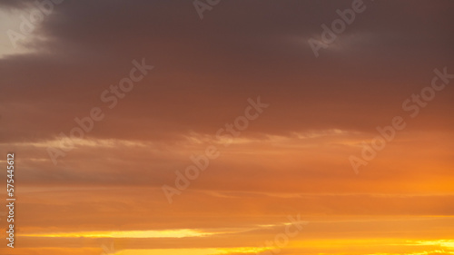 Beautiful bright orange sunset sky with dramatic clouds. Sunset sky with clouds background. © Inga Av