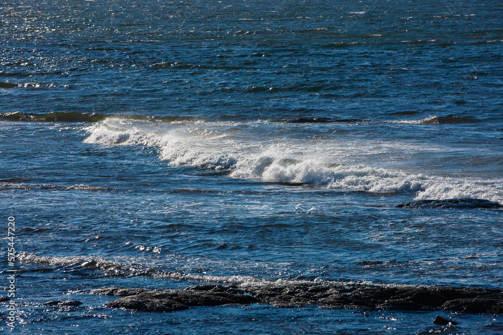 Waves forming and breaking in the Ocean by the shoreline. Waves forming and breaking in the Ocean by the shoreline.