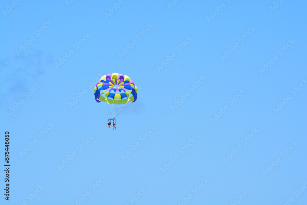Fototapeta premium People parasailing high in the sky. 
