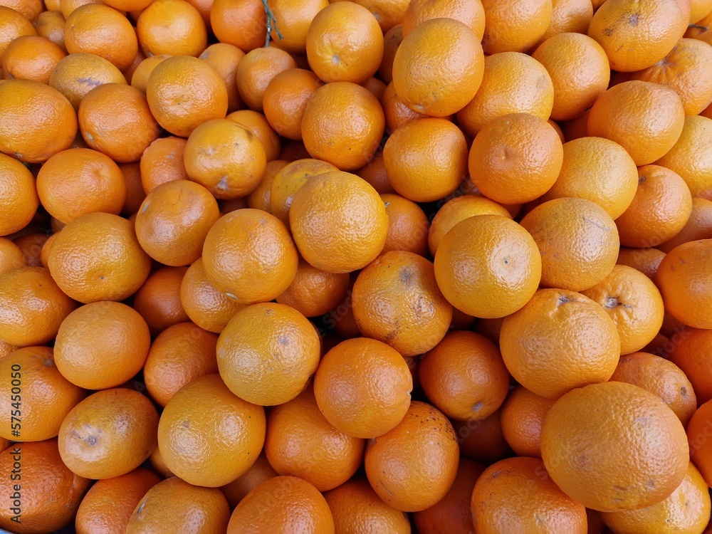 fruit background of ripe healthy oranges at the market stall