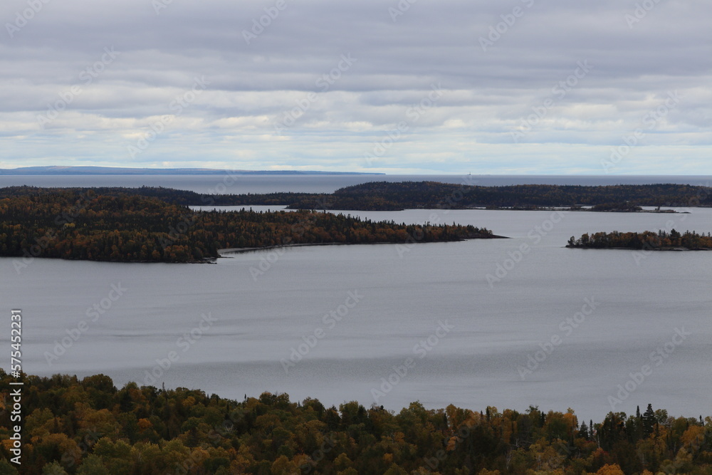 View of Lake Superior rocks and beach with autumn trees in Grand Marais, in Northern Minnesota 