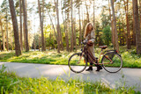 Beautiful woman  riding bicycle in  park. Lifestyle. Relax, nature concept. Spring time.
