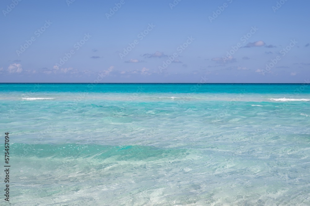 Varadero beach in Cuba in the year 2023. Blue sea, clear sky and many tourists on the beach.