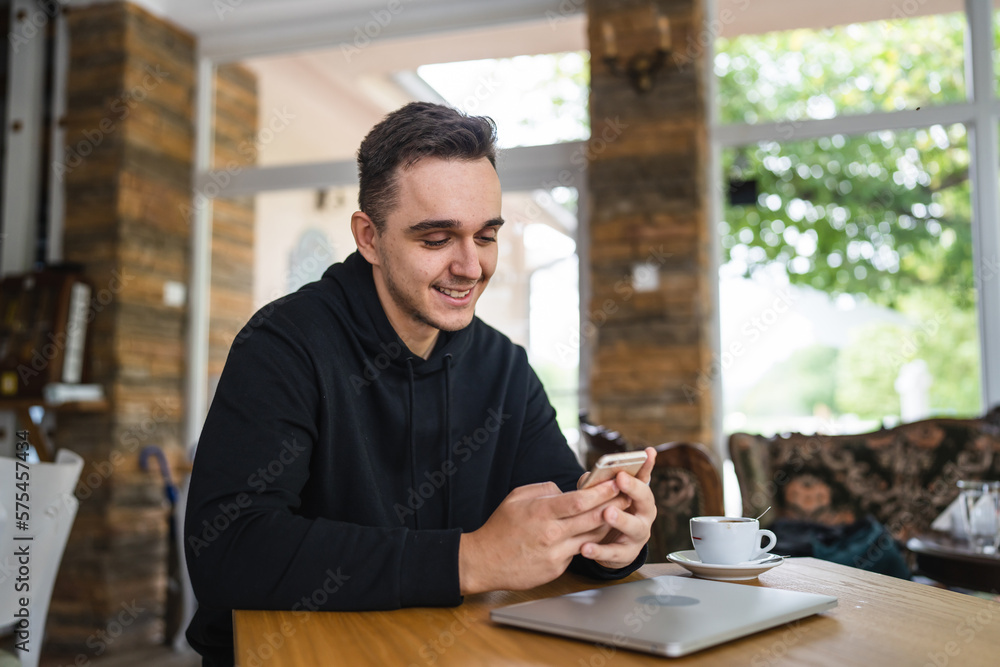 one man use mobile phone while sit at the table at restaurant one man use mobile phone while sit at the table at restaurant