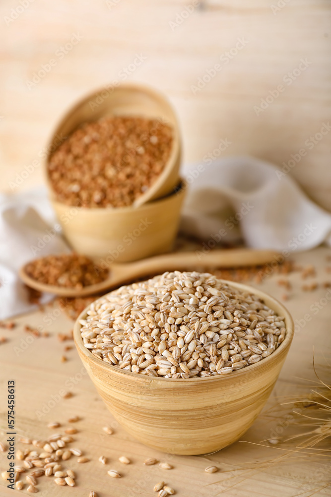 Bowl with pearl barley on wooden background Bowl with pearl barley on wooden background