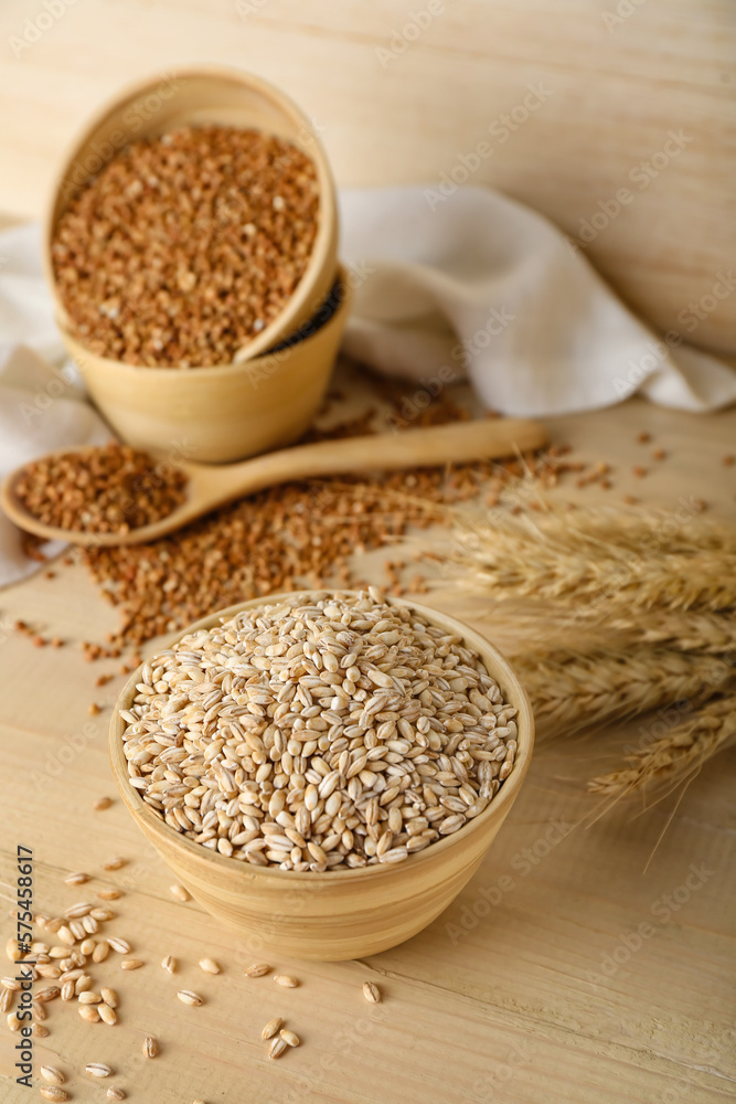 Bowl with pearl barley on wooden background Bowl with pearl barley on wooden background