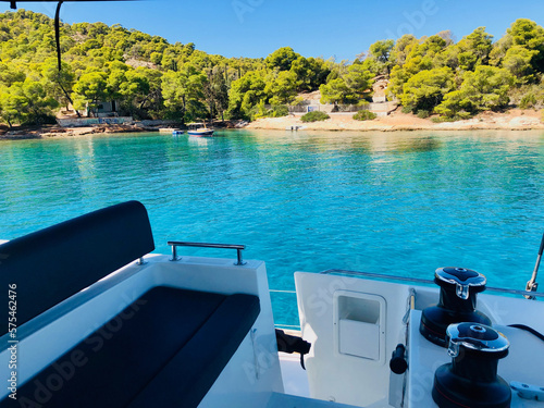 Beautiful turquoise waters on a sunny day seen from the bridge of a sailing catamaran at Spetsai island