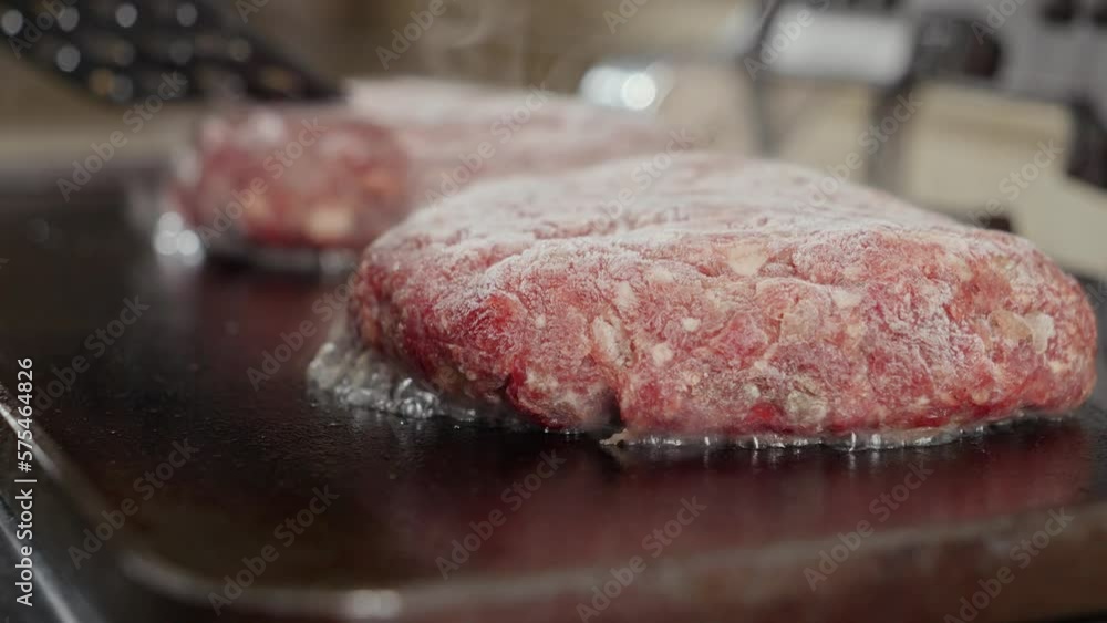 Closeup of juice flowing and boiling from hamburger patties. Cooking at home, kitchen appliance, healthy nutrition, hamburger ingredients Closeup of juice flowing and boiling from hamburger patties. Cooking at home, kitchen appliance, healthy nutrition, hamburger ingredients