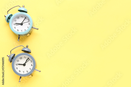 Alarm clocks on yellow back...