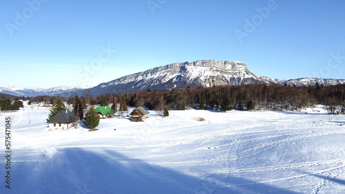 Panoramic view of snowy mountains in winter. Foggy mountains. Woods in front of the mountains. Mountains resort station.