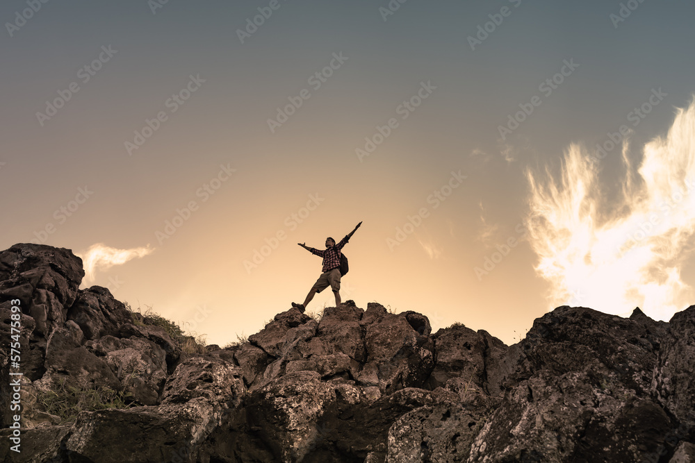 Hiker with arms up standing on the top of the mountain - Successful man enjoying triumph - Sport and success concept
 - obrazy, fototapety, plakaty 