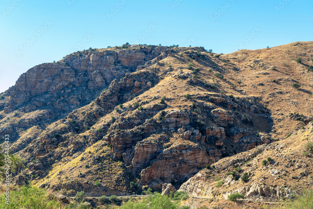 Rolling mountain hills with road and transportation in the cliffs and ridges of wild west great outdoors arizona
