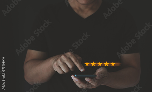 Product or service review ideas from customers. Customer giving a gold five star rating feedback on smartphone. Review, satisfaction the products and services increase the credibility of the store.