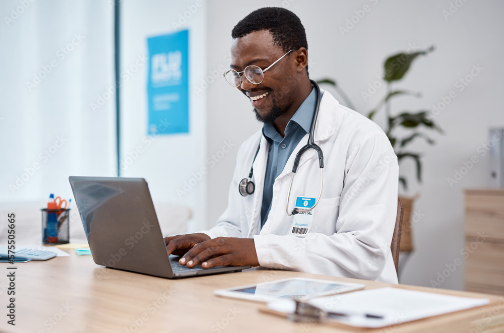 Black man, doctor and laptop with smile in healthcare for research, medicine or PHD at clinic desk. Happy African American male medical professional smiling, working or typing on computer at hospital