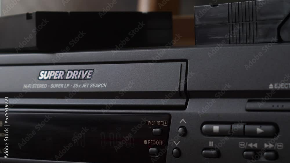 close-up of a video cassette with the inscription birthday is loaded into a vintage video player. selective focus. archival home family footage close-up of a video cassette with the inscription birthday is loaded into a vintage video player. selective focus. archival home family footage