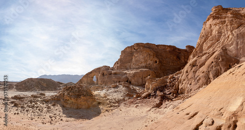The famous stone arch, resulting from the erosion of the rock, in the midst of fantastically beautiful landscape in the national park Timna, near the city of Eilat, in southern Israel