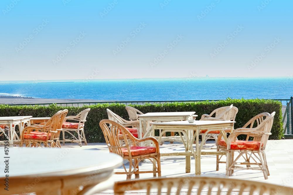 Beautifully stylish table chairs for eating people at sea background