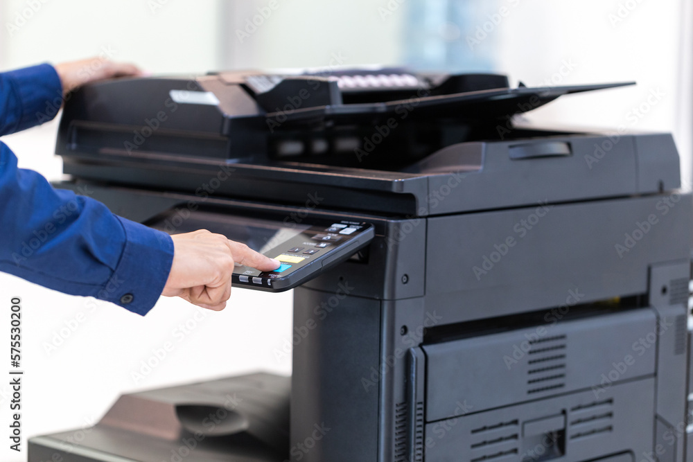 Businessman press button on panel of printer photocopier network , Working on photocopies in the office concept , printer is office worker tool equipment for scanning and copy paper. Businessman press button on panel of printer photocopier network , Working on photocopies in the office concept , printer is office worker tool equipment for scanning and copy paper.