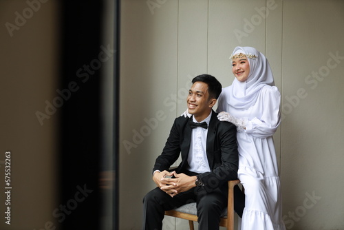 romantic prewedding photo couple of asian man and asian girls wearing neat suits black suits and white dresses indoor concept