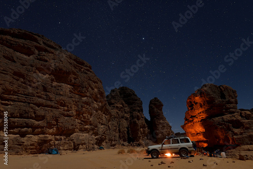 STARRY NIGHT AND THE ROCK FORMATIONS DURING CAMPING IN THE SAHARA DESERT IN ALGERIA