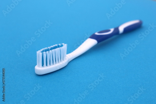 On a blue background lies a new toothbrush.