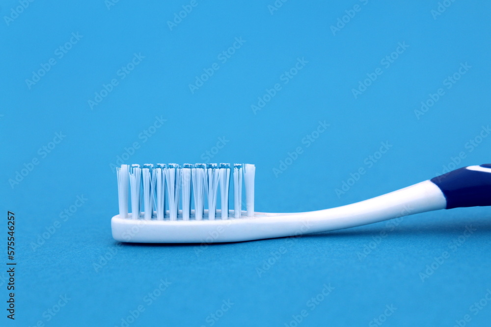On a blue background lies a new toothbrush. On a blue background lies a new toothbrush.